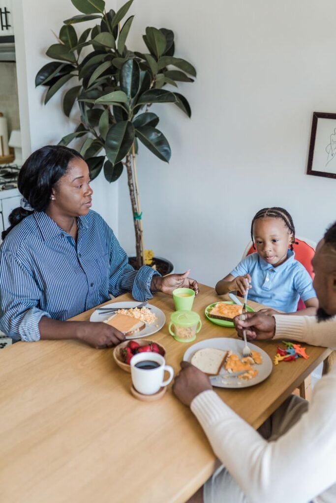 Happy family enjoying breakfast together at home around a dining table.