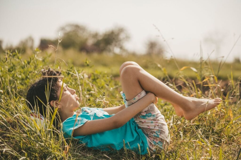 Young boy enjoying leisure in a sunny meadow, capturing the essence of carefree summer days.
