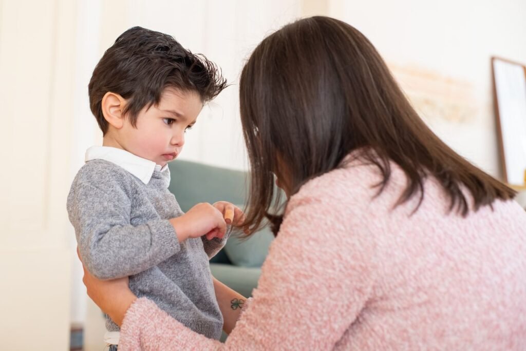 A mother consoles her child in a serene indoor setting, capturing a tender moment.