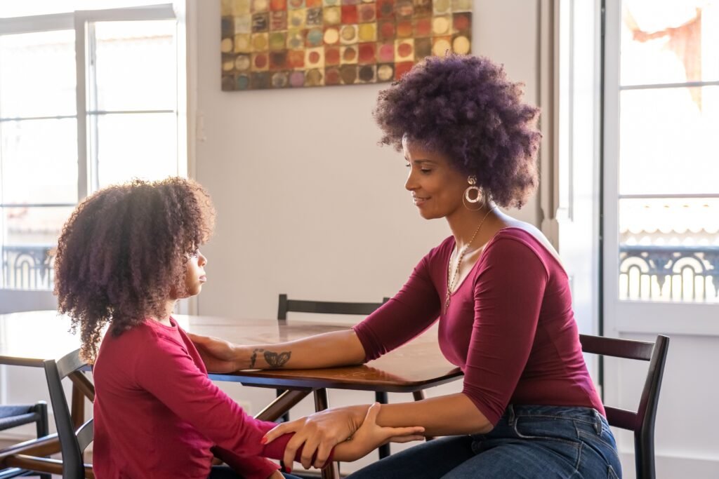 pexels-photo-6297586-6297586 A mother and daughter sit together, sharing a warm and intimate moment indoors.