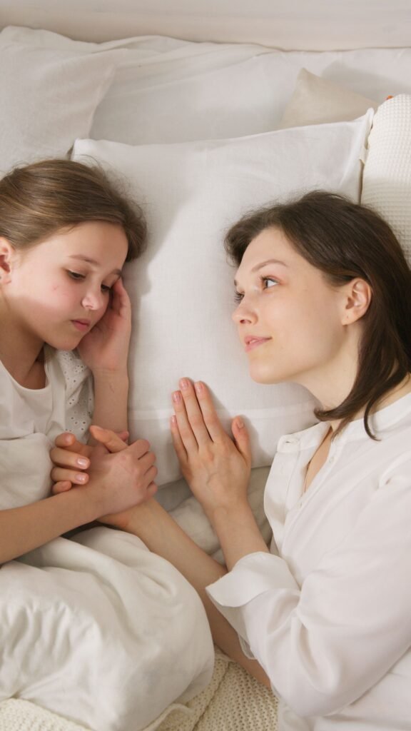 pexels-photo-7505013-7505013 A caring mother and her daughter share a tender moment in bed, embracing family love.