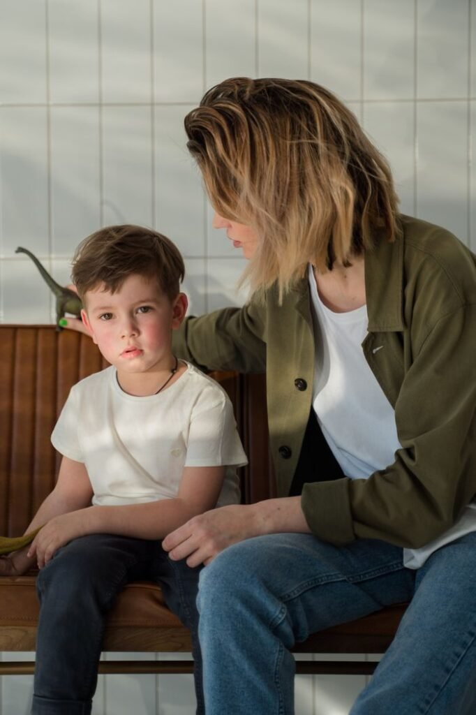 pexels-photo-9478044-9478044 A mother and her young son sitting together indoors in a moment of bonding and affection.