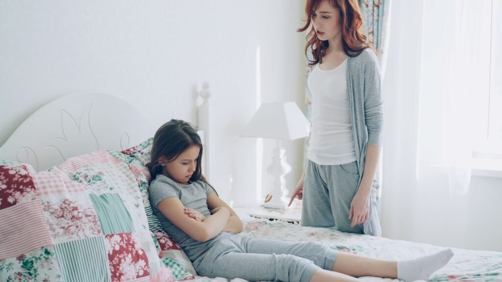 Mother and daughter in emotional discussion at home. Bright, serene setting.